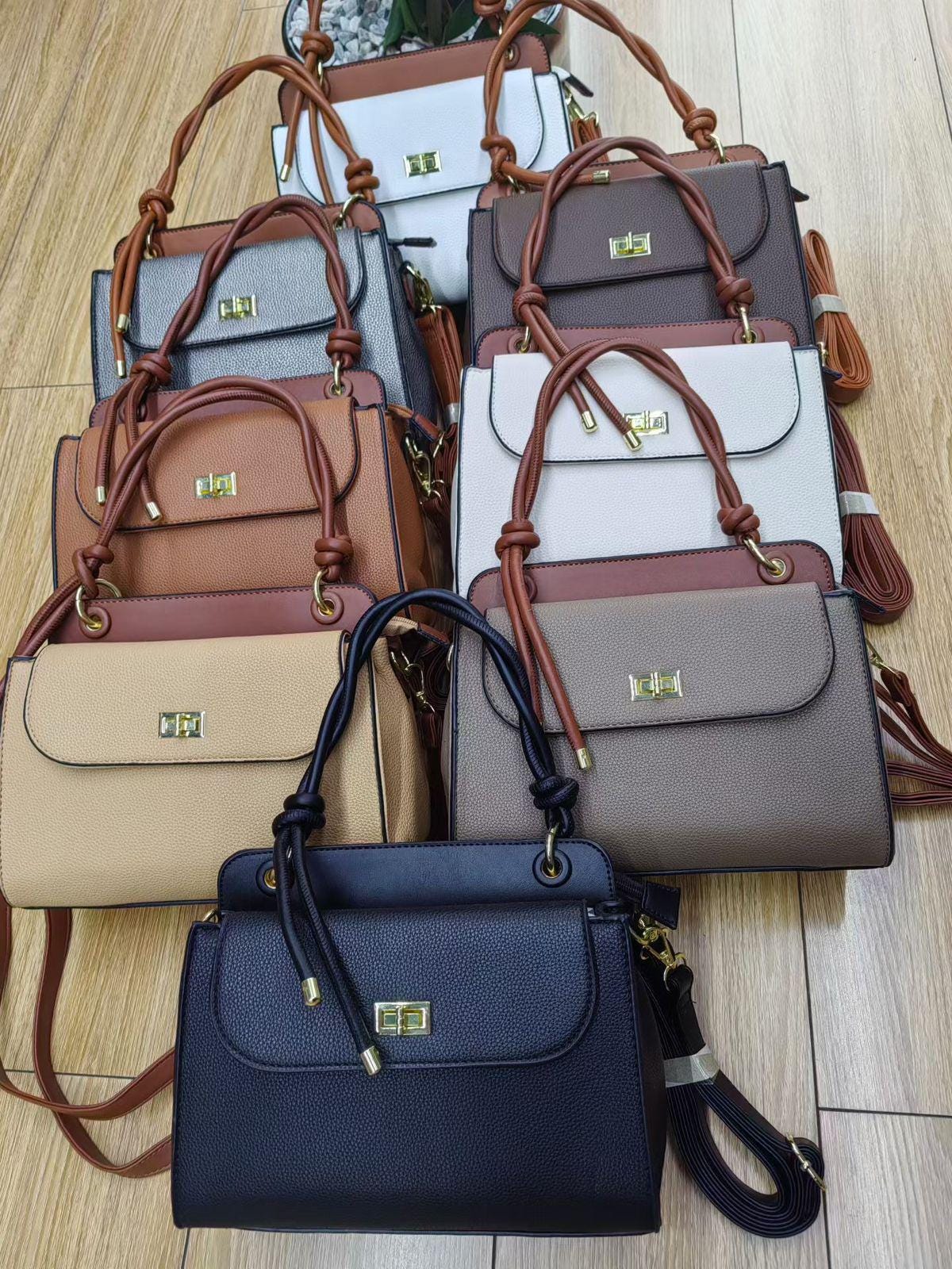 Lace & Luxe pebbled leather handbag with structured top handle and crossbody strap, stylish women's purse with gold hardware.