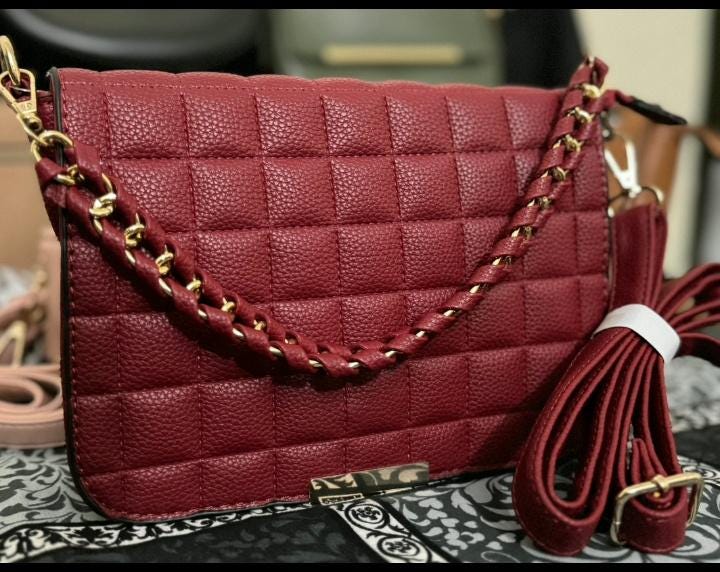 Lace & Luxe quilted leather crossbody bag with gold chain handle, featuring a sleek and stylish design for everyday use.