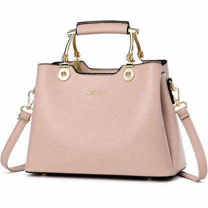 Blush pink vegan leather structured satchel handbag with gold hardware and top handle, featuring a crossbody strap for women.