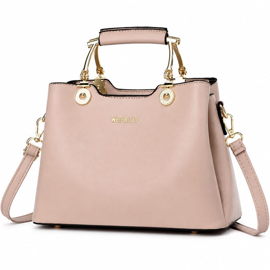 Blush pink vegan leather structured satchel handbag with gold hardware and top handle, featuring a crossbody strap for women.
