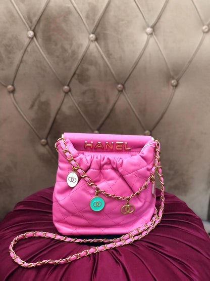 Hot pink quilted faux leather crossbody bag with gold chain shoulder strap from Lace & Luxe, featuring a stylish, textured design.