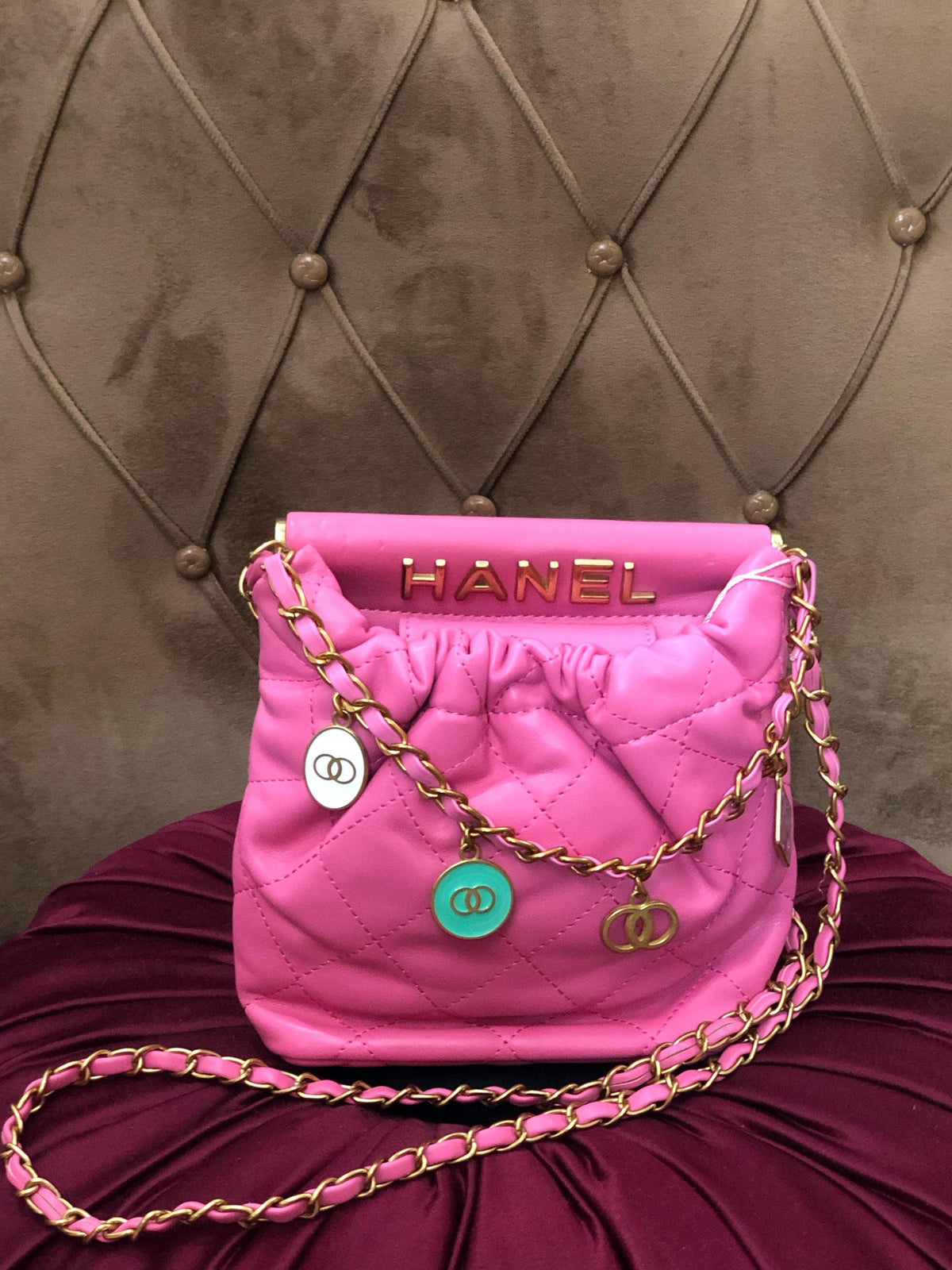 Hot pink quilted faux leather crossbody bag with gold chain strap by Lace & Luxe, showing the stylish purse with textured surface.