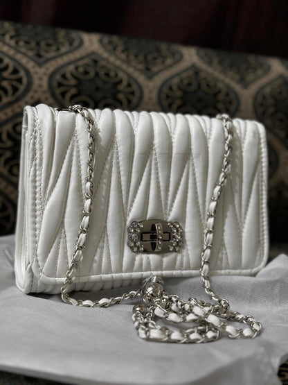 Lace & Luxe leather quilted mini bag with chain crossbody strap, featuring a compact purse design and elegant stitching.