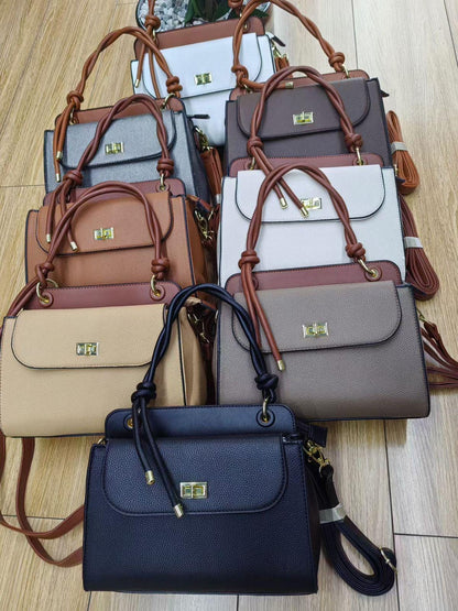 Lace & Luxe pebbled leather handbag with structured top handle and crossbody strap, stylish women's purse with gold hardware.