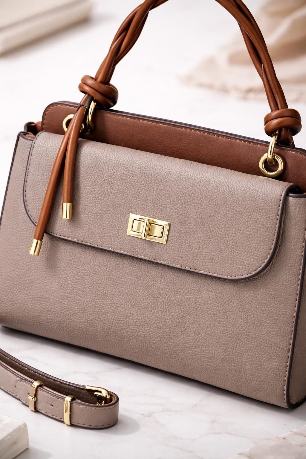 Lace & Luxe pebbled leather handbag with structured top handle and crossbody strap, designed for women.