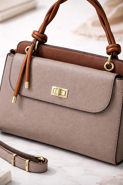 Lace & Luxe pebbled leather handbag with structured top handle and crossbody strap, designed for women.