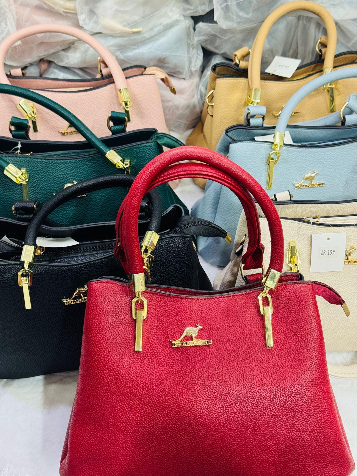 Leather top handle handbag by Lace & Luxe with gold key charm, structured shoulder bag with elegant design and durable leather.