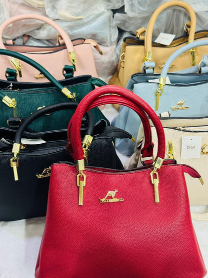 Leather top handle handbag by Lace & Luxe with gold key charm, structured shoulder bag with elegant design and durable leather.