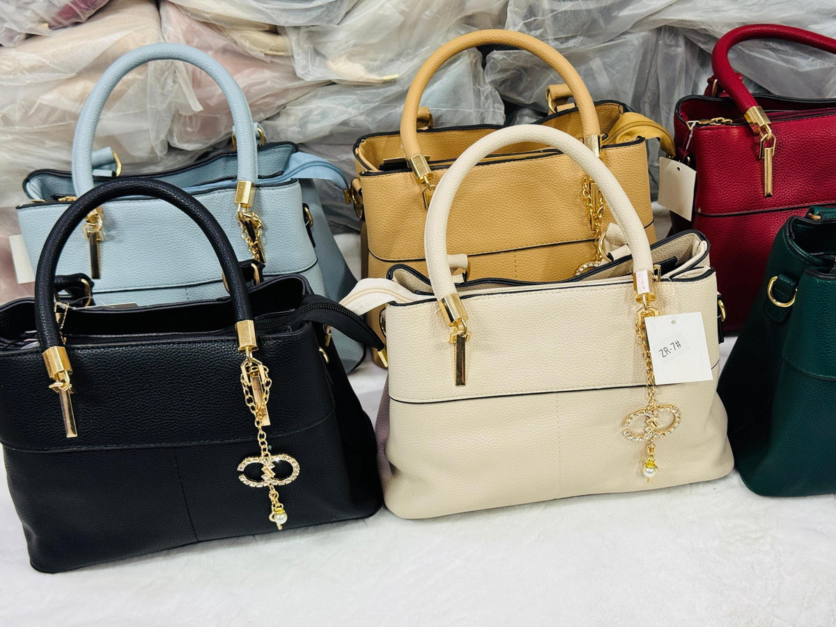Faux leather top handle bag with gold charm from Lace & Luxe, featuring a crossbody purse design for women.