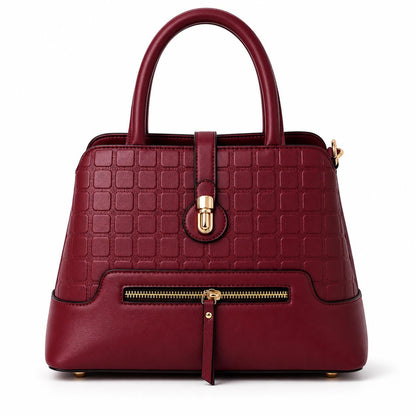 Leather satchel bag with geometric textured pattern and gold latch, lace & luxe crossbody purse with structured design.