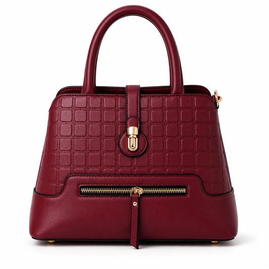 Leather satchel bag with geometric textured pattern and gold latch, lace & luxe crossbody purse with structured design.