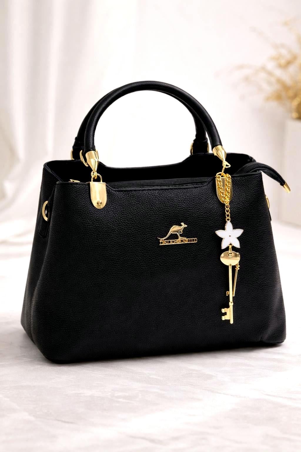Leather top handle handbag with gold key charm from Lace & Luxe, featuring a structured shoulder bag design and elegant detailing.