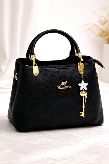 Leather top handle handbag with gold key charm from Lace & Luxe, featuring a structured shoulder bag design and elegant detailing.