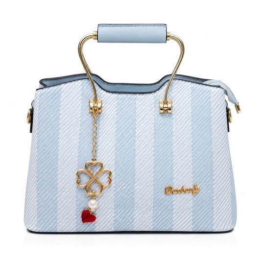 Lace & Luxe striped satchel handbag with gold top handle, leather shoulder strap, and clover charm accessory.