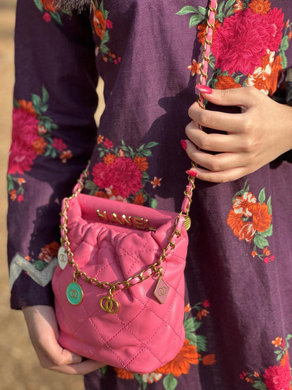 Hot pink quilted faux leather crossbody bag with gold chain shoulder strap from Lace & Luxe, showing the bag's vibrant color and textured design.