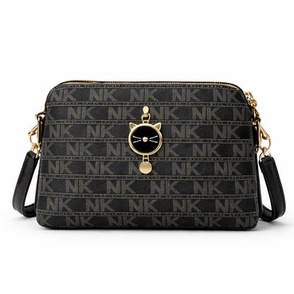 Black monogram crossbody bag with cat charm from Lace & Luxe, small patterned shoulder purse for women, stylish and compact.