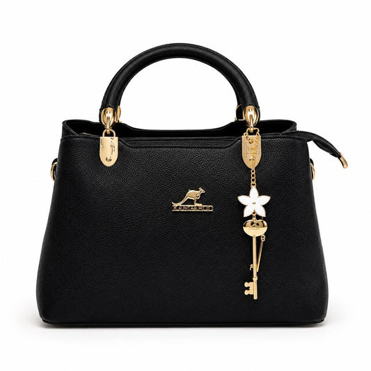 Leather top handle handbag by Lace & Luxe featuring a gold key charm, structured shoulder bag with elegant design.