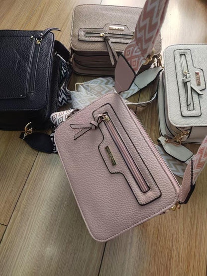 Small Lace & Luxe crossbody handbag with adjustable chevron strap and stylish design for women.