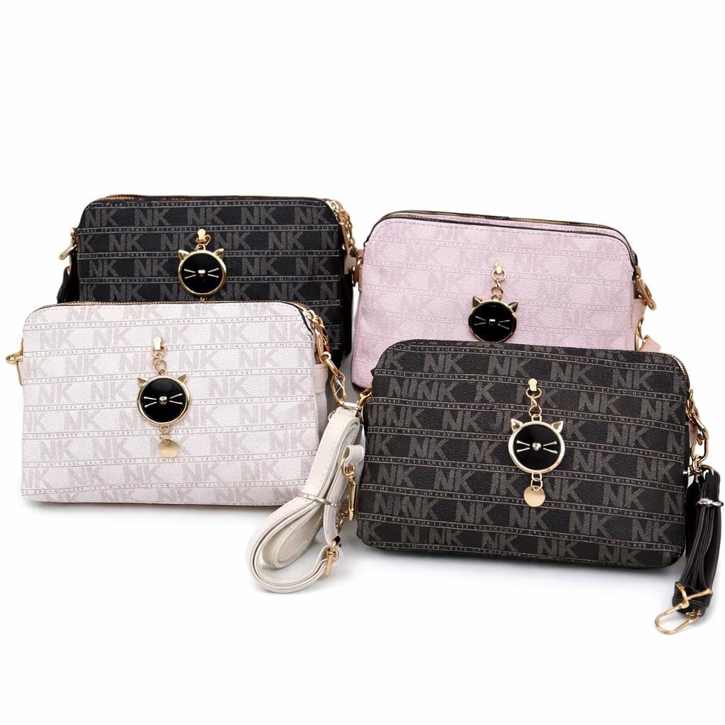 Black Lace & Luxe monogram crossbody bag with cat charm, small patterned shoulder purse for women, stylish and compact accessory.